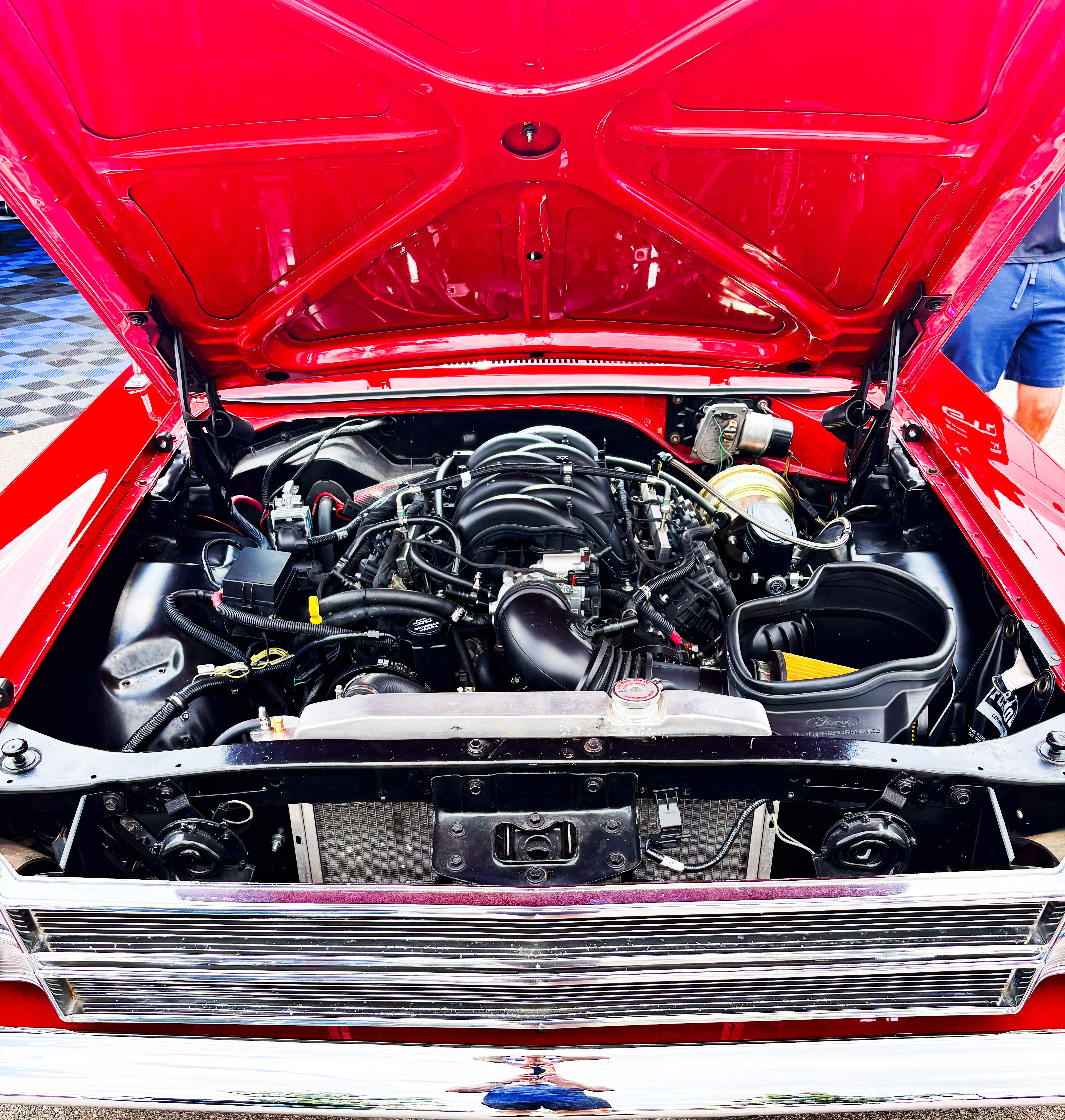 Ford display of a 430-horsepower, 7.3-liter 'Godzilla' crate engine in a classic automobile.